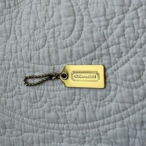Coach metal hangtag in gold
